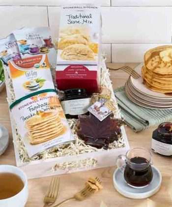Breakfast gift basket with pancake mix, maple syrup, coffee, scone mix, and blueberry preserves in a white crate