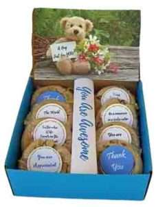 Box of cookies with personalized labels and picture of bear holding card saying "A hug for you."