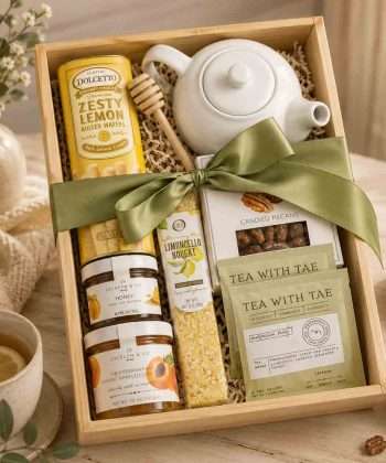 Tea gift box with ceramic teapot, premium tea, raw honey, lemon cookies, artisan preserves and wooden keepsake gift box.