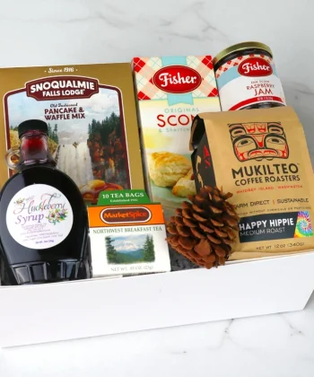 White gift box filled with gourmet breakfast foods and beverages